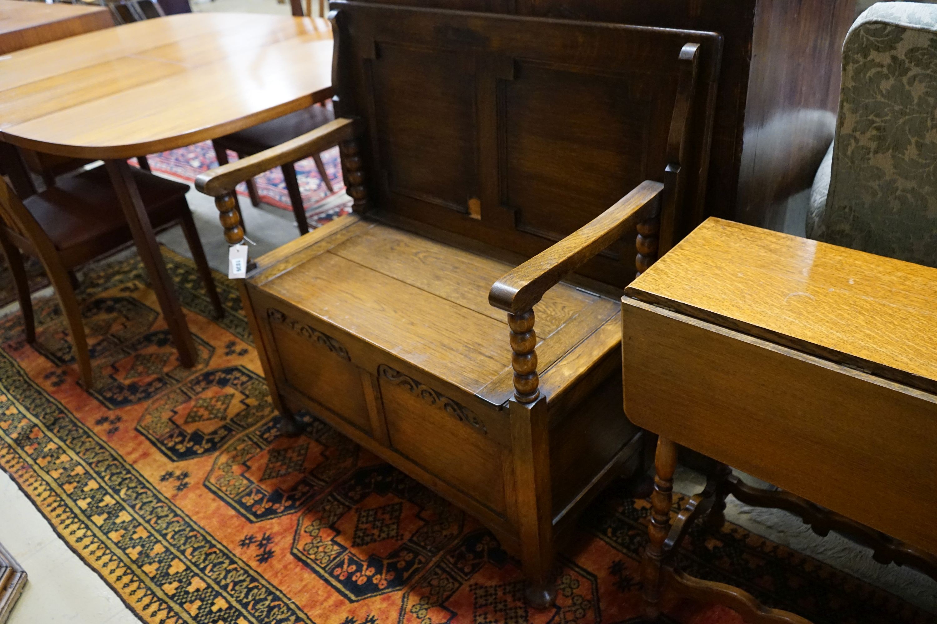 An oak monk's bench with folding top and locker seat, length 91cm, depth 47cm, height 92cm